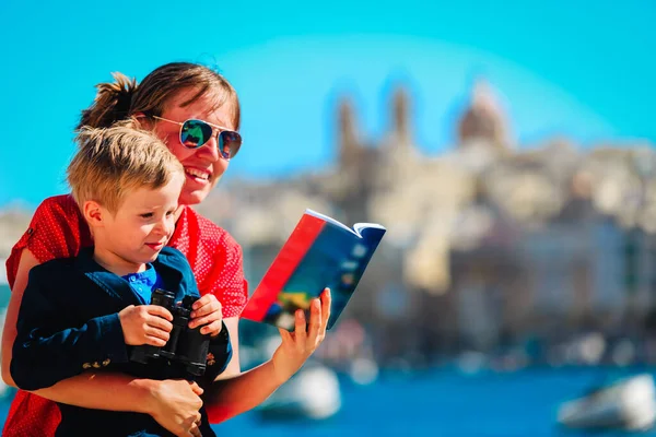 Mother and son travel in Malta, Europe, family looking at travel guide book — Stock Photo, Image