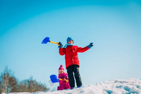 Happy kids- boy and girl- play with snow in winter nature — Stock Photo, Image