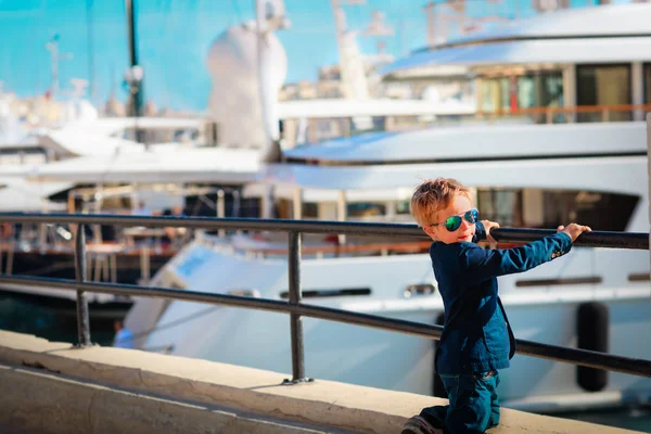 Słodkie chłopiec patrząc na luksusowe jachty na nabrzeżu — Zdjęcie stockowe