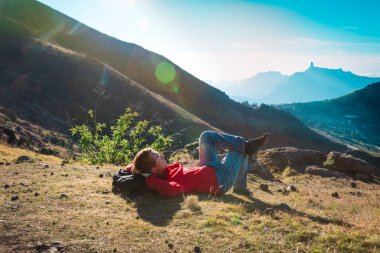 tourist relax while travel in mountains at sunset
