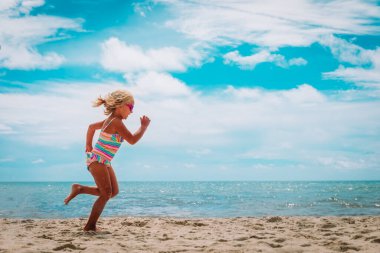 cute girl run on beach, kid exercise, healthy lifestyle