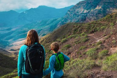 mother and son travel in nature, family looking at scenic landscape
