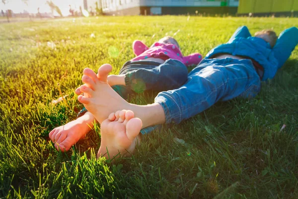 Щасливі діти ноги на зеленій траві, літній відпочинок — стокове фото