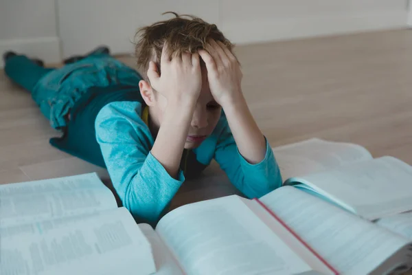 Young boy tired of reading, kid having too much homework — Stock Photo, Image