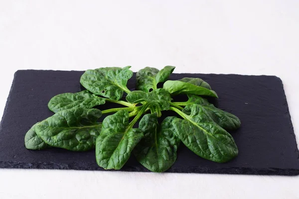 Fresh spinach on a dark stone . Healthy eating concept. Dieting. — Stock Photo, Image