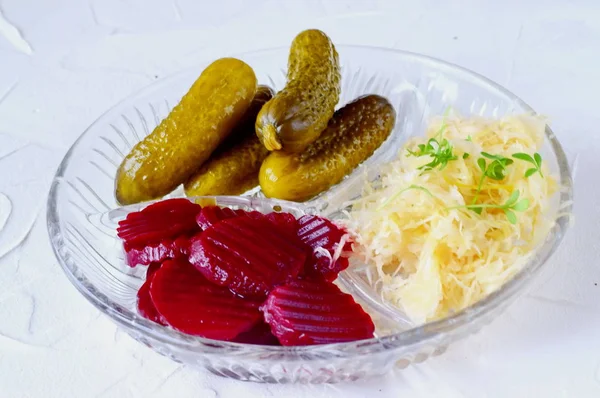 Healthy lunch or dinner with smoked mackerel, pickled cucumbers, beetroot, sauerkraut, french fries on a grey abstract background. Healthy food. Food for fastening. — Stock Photo, Image