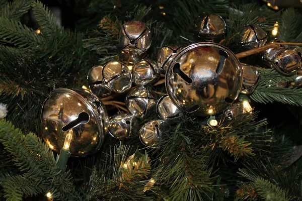 Shiny Gold Jingle Bells Hanging on a Christmas Tree — Stock Photo, Image
