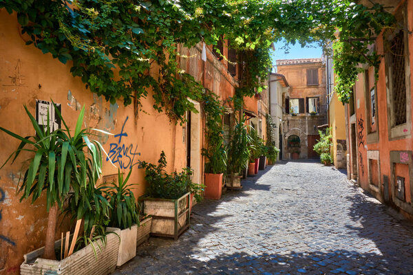 ROME, ITALY - MAY 17, 2017: Picturesque houses in an alley at Trastevere in Rome, Italy.