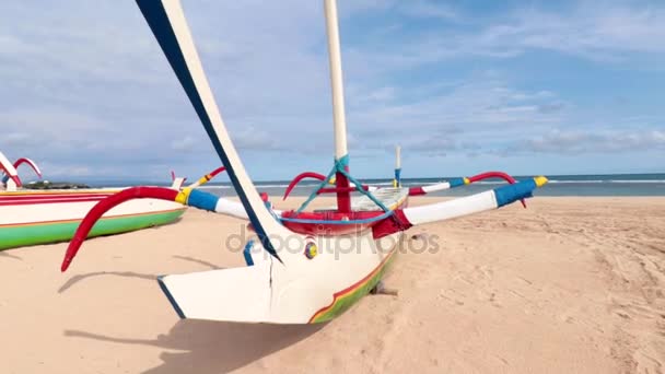 Houten kleurrijke vissersboten op het strand met blauwe lucht. Nusa Dua, Bali, Indonesië. Slow motion. — Stockvideo