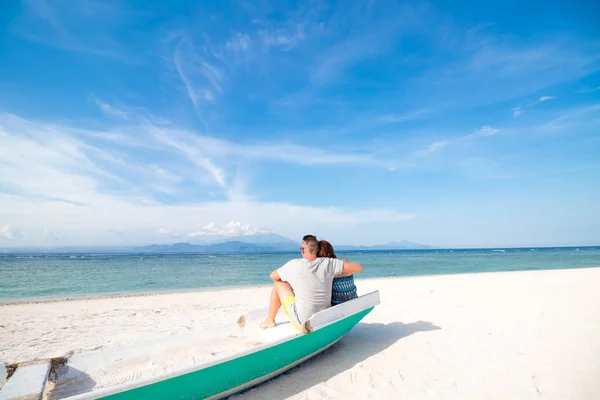 楽園で幸せな新婚旅行の休暇。カップルは、古いボートに座っているビーチの白い砂浜でリラックスします。幸せな海のライフ スタイル。若い家族、男と女の海のビーチで休んでください。愛のカップル — ストック写真