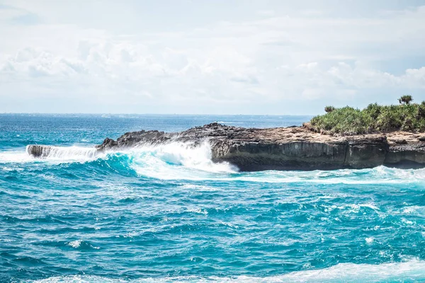 A beautiful blue wave crashes down at the rocks in Devils Tear, tropical island Nusa Lembongan, Indonesia, Asia. Sunny day, big waves. — Free Stock Photo