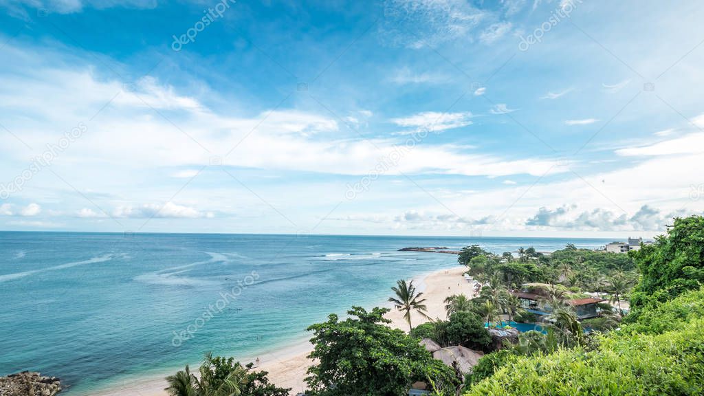 Tropical island landscape, ocean on a bacakground. Beautiful view from the cliff to the coast. Outdoor scenery, Bali island, Indonesia.