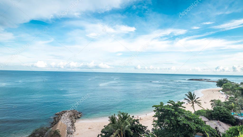 Tropical island landscape, ocean on a bacakground. Beautiful view from the cliff to the coast. Outdoor scenery, Bali island, Indonesia.