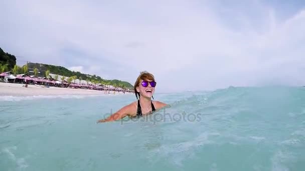 웃는 동안 그녀는 열 대 발리 섬, 인도네시아의 바닷가에 바다에 귀여운 여자의 슬로우 모션. 판다와 비치입니다. 판 타이 판다와, 아시아 화창한 날. — 비디오