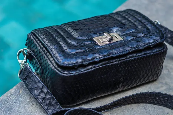 Bags fashion trends. Close up of gorgeous stylish snakeskin python bag. Luxury handbag closeup.
