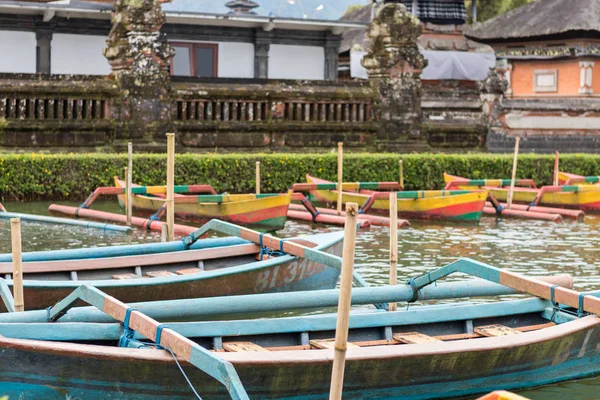 Colorful wooden fishing boats on the balinese temble background. Tropical magic island Bali, Indonesia.