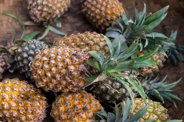 Stapel van tropische biologische ananassen fruit in mand voor verkopen in traditioneel landbouwer markt van Bali eiland, Indonesië. — Stockfoto