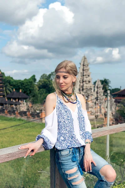 Attractive young woman in ethnic style look posing near the balinese temple, portrait. Tropical island Bali, luxury resort villa, Indonesia.