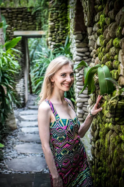 Beautiful slender woman among tropical plants. Beauty, fashion. Spa, healthcare. Tropical vacation. Bali island.