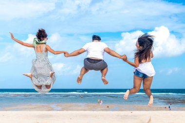 Çok ırklı arkadaşlar eğlenmeye tropikal Bali Adası, Endonezya kumsalda grup.