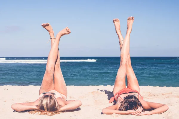 Twee gelukkige sexy vrouwen vrienden zonnebaden op het eiland van de tropische strand van Bali, Nusa Dua, Indonesië. — Stockfoto