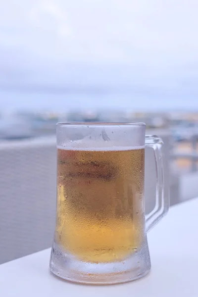 Glass of light beer on the table in outside cafe, Bali island, Indonesia. — Stock Photo, Image