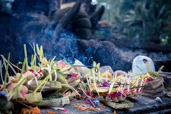 Traditional balinese offerings to gods in Bali with flowers and aromatic sticks. Bali island. Royalty Free Stock Photos