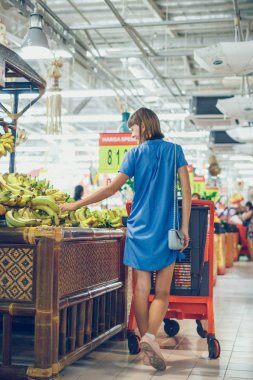 BALI, INDONESIA - OCTOBER 2, 2017: Young woman at supermarket Bali Gallery, Bali island, Indonesia.