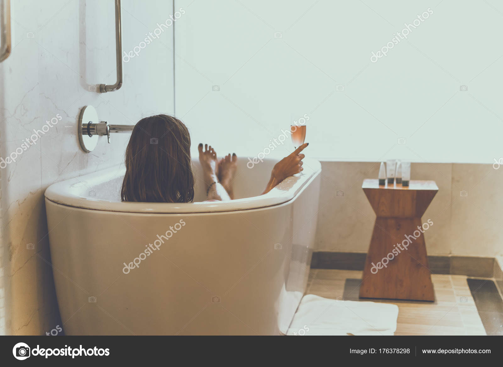 Young Attractive Woman With Champagne Glass Relaxing In Bath