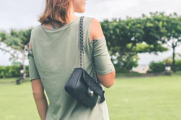 Seksi genç kadın lüks el yapımı yılan derisi deri çanta ile. Piton yılan moda çanta. Açık havada, Bali Adası.