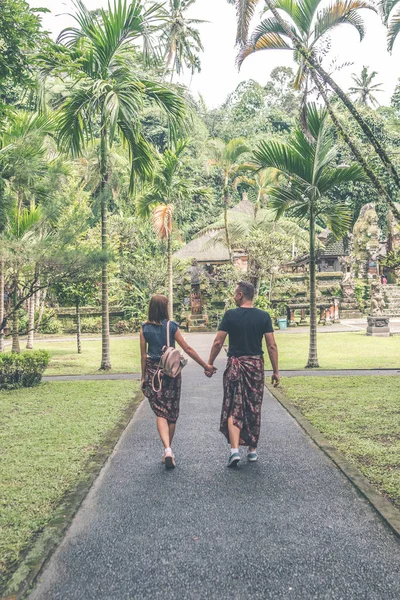 European honeymoon couple in the balinese temple area. Tropical island of Bali, Indonesia.