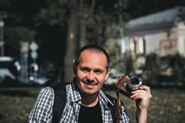 Man holding retro camera. Vintage camera. Photographer.