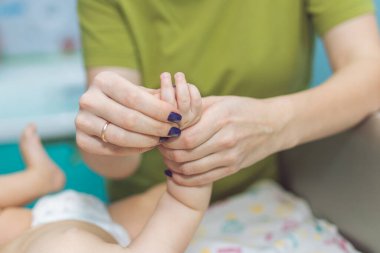 Baby massage. Mother is massaging the baby. Health massage.
