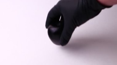 Funny black apple isolated on a white background. Full HD shot.
