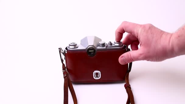 Vintage photo camera isolated on a white background in man hands. Old retro camera. — Stock Video