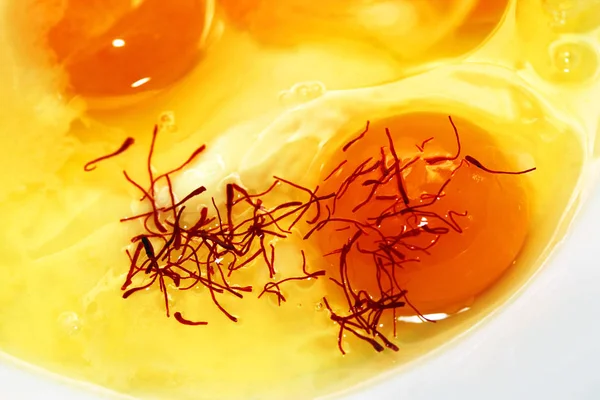 Raw egg with saffron — Stock Photo, Image