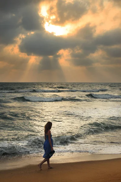 Fille sur une plage au coucher du soleil — Photo