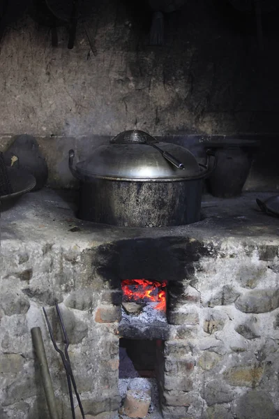 An old stone stove with an saucepan — Stock Photo, Image