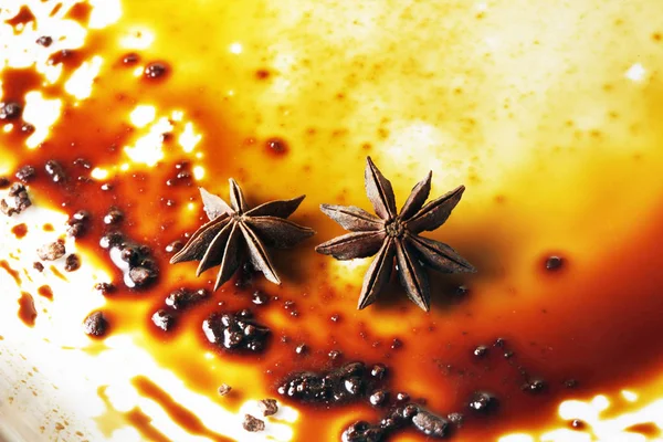 Asterisks anise on a plate with chocolate sauce — Stock Photo, Image