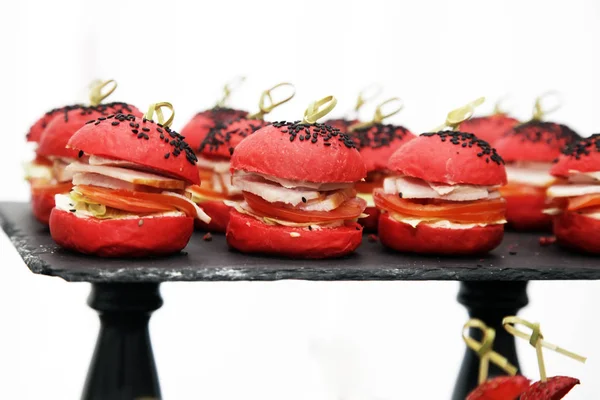 Mini burgers with red bun, stuffed with ham and tomato — Stock Photo, Image