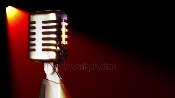 Classic vocal microphone rotating in stage lights — Stock Video