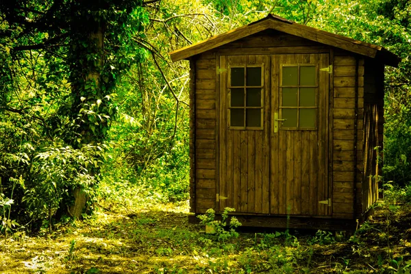 Red wooden hunting lodge in the deep forest