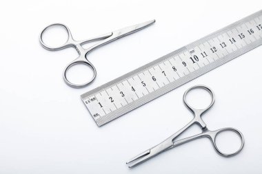 Çelik cerrahi aletler ve laboratuvar ekipmanları beyaz arka planda izole edilmiş. Profesyonel klinik aletleri. Tıbbi, cerrahi, ambulans ve veteriner konsepti. Yumuşak seçici odaklı yakın plan