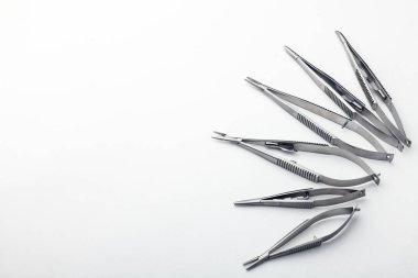 Çelik cerrahi aletler ve laboratuvar ekipmanları beyaz arka planda izole edilmiş. Profesyonel klinik aletleri. Tıbbi, cerrahi, ambulans ve veteriner konsepti. Yumuşak seçici odaklı yakın plan