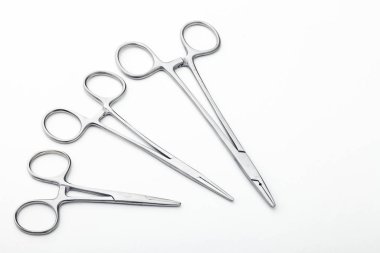 Çelik cerrahi aletler ve laboratuvar ekipmanları beyaz arka planda izole edilmiş. Profesyonel klinik aletleri. Tıbbi, cerrahi, ambulans ve veteriner konsepti. Yumuşak seçici odaklı yakın plan