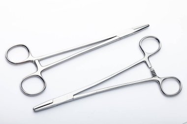 Çelik cerrahi aletler ve laboratuvar ekipmanları beyaz arka planda izole edilmiş. Profesyonel klinik aletleri. Tıbbi, cerrahi, ambulans ve veteriner konsepti. Yumuşak seçici odaklı yakın plan