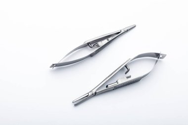 Çelik cerrahi aletler ve laboratuvar ekipmanları beyaz arka planda izole edilmiş. Profesyonel klinik aletleri. Tıbbi, cerrahi, ambulans ve veteriner konsepti. Yumuşak seçici odaklı yakın plan