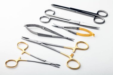 Çelik cerrahi aletler ve laboratuvar ekipmanları beyaz arka planda izole edilmiş. Profesyonel klinik aletleri. Tıbbi, cerrahi, ambulans ve veteriner konsepti. Yumuşak seçici odaklı yakın plan