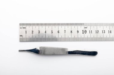 Çelik cerrahi aletler ve laboratuvar ekipmanları beyaz arka planda izole edilmiş. Profesyonel klinik aletleri. Tıbbi, cerrahi, ambulans ve veteriner konsepti. Yumuşak seçici odaklı yakın plan