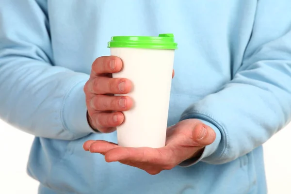 Human hand holds a blank paper Coffee cup with plastic cap. Concept of tea or coffee to go in a disposable mug. Mockup with copy space and place for text or logo. Isolated on a white background